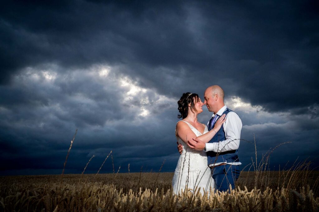 Evening shot in wheat field with bride and groom at Kins Croft Hotel in Pontefract