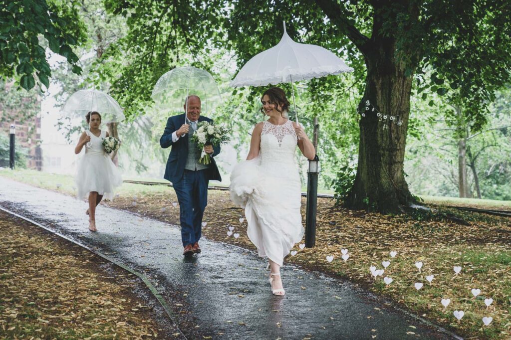 Bride no the way to the ceremony in the rain in Mirfield