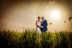 Bride and groom in wheat field